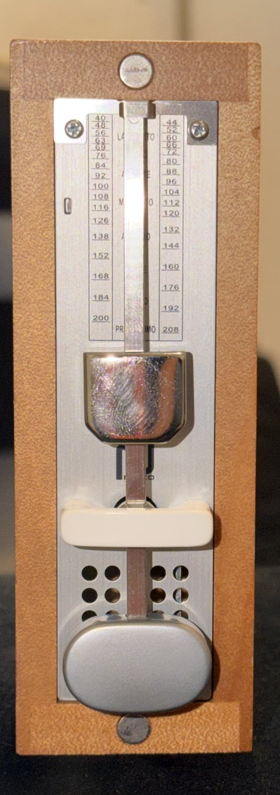 A NIKKO Wooden Mini Advance metronome, its weight set near the top of the scale.
